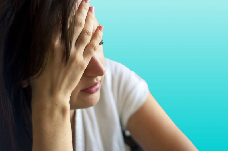 fatigue - müde Frau hält sich Hand vor die Stirn